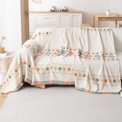 Housse réversible pour canapé bohème avec pompons – style chic et cosy