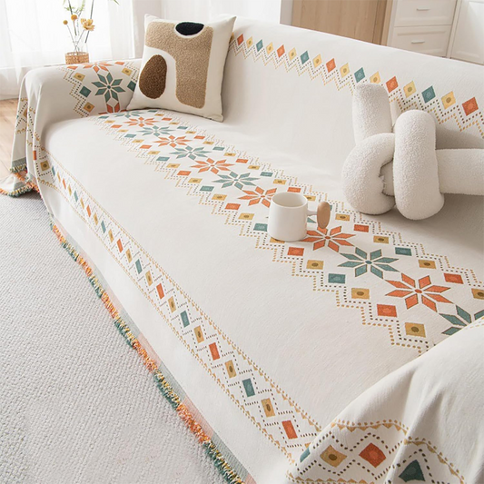Housse réversible pour canapé bohème avec pompons – style chic et cosy